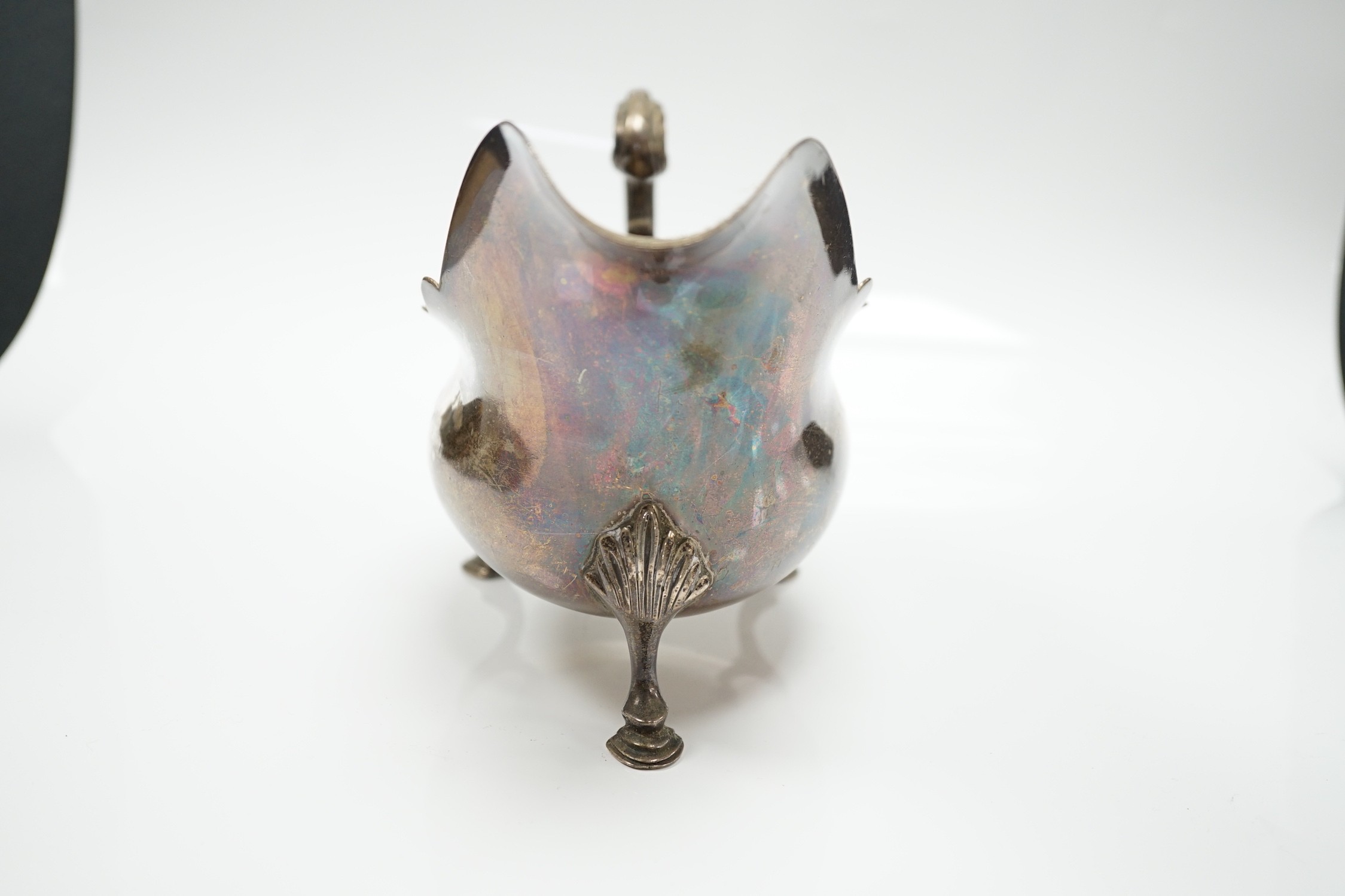 A late Victorian silver sauce boat, with flying scroll handle, Charles Boyton, London, 1897, length 21.6cm, 14.1oz.